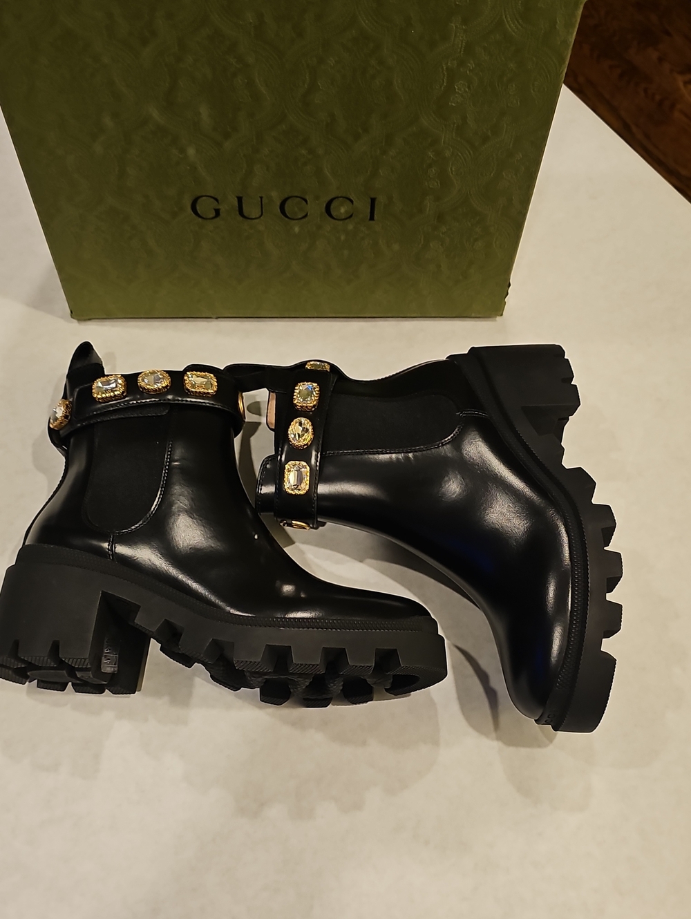 Gucci Black Leather Lug-Sole Ankle Boots with Gold Jewel Strap